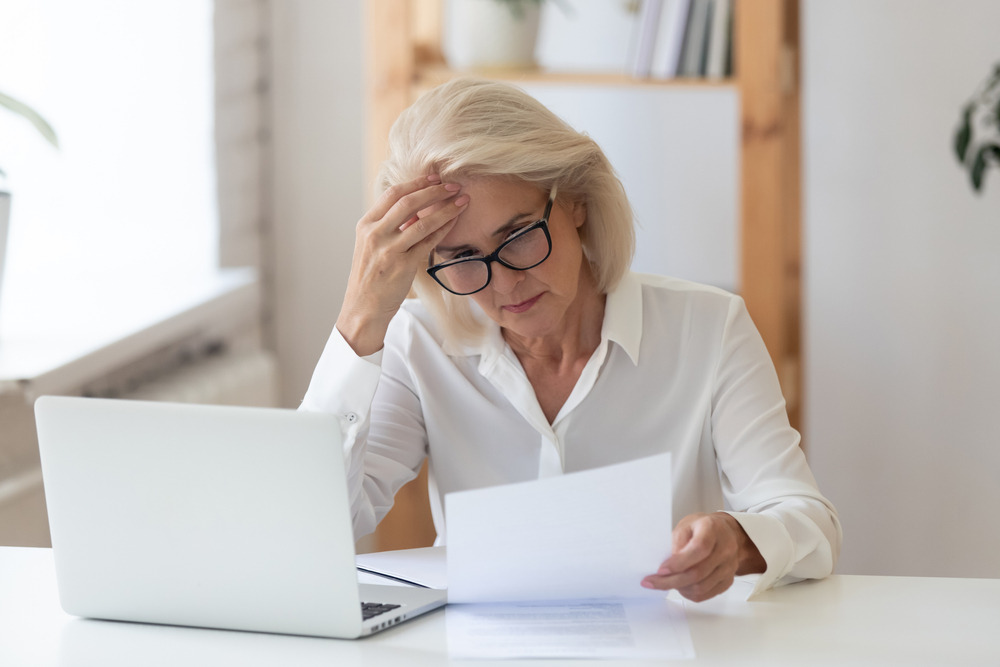 Lady stressed by filing his taxes late (Big Mistake Filing Your Tax Return Late)